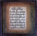 Brown Frame with Surah Al-A'laa on Textured Surface